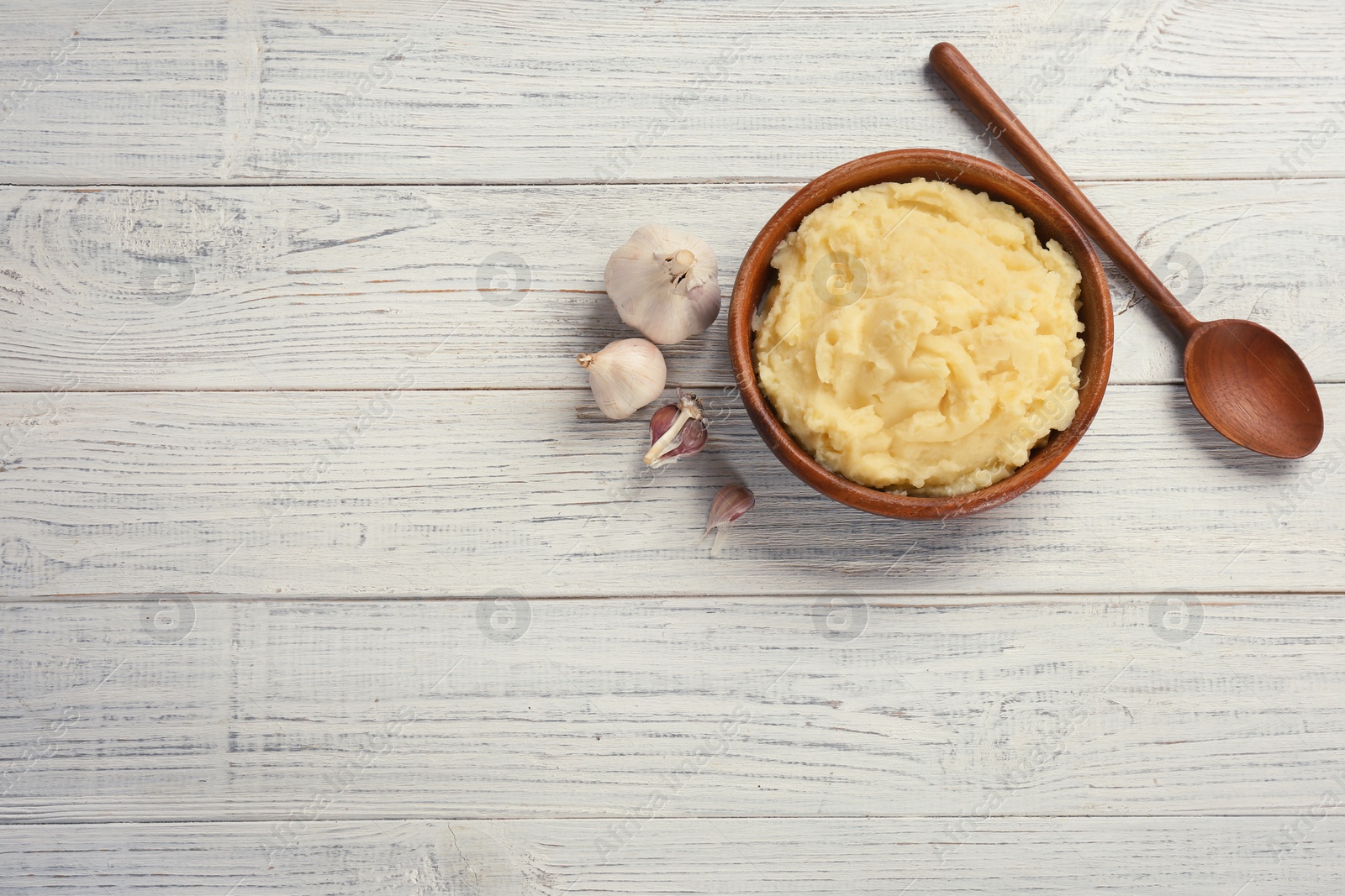 Photo of Flat lay composition with mashed potatoes on wooden background. Space for text