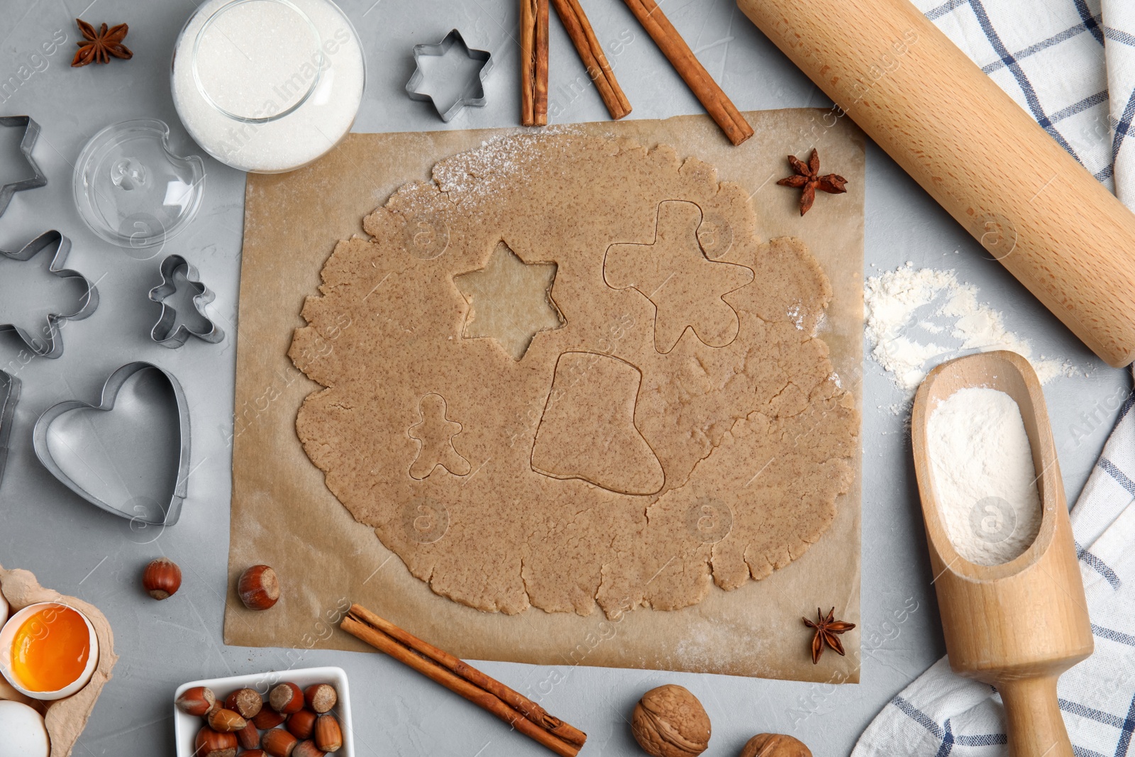 Photo of Homemade Christmas cookies. Flat lay composition with dough and ingredients on light grey table