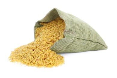 Overturned sack with uncooked bulgur on white background