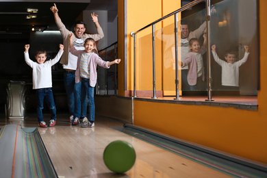 Happy family spending time together in bowling club