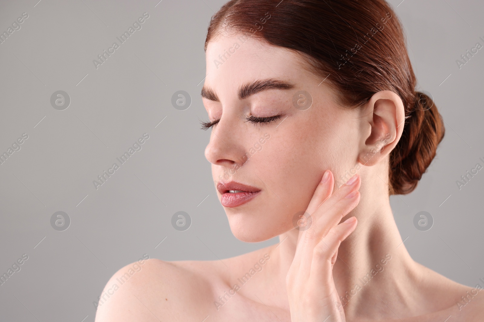 Photo of Portrait of beautiful woman on grey background, closeup