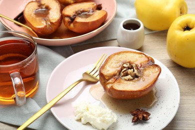 Delicious quince baked with honey and walnuts on wooden table