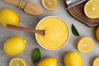 Delicious lemon curd and fresh fruits on light grey table, flat lay