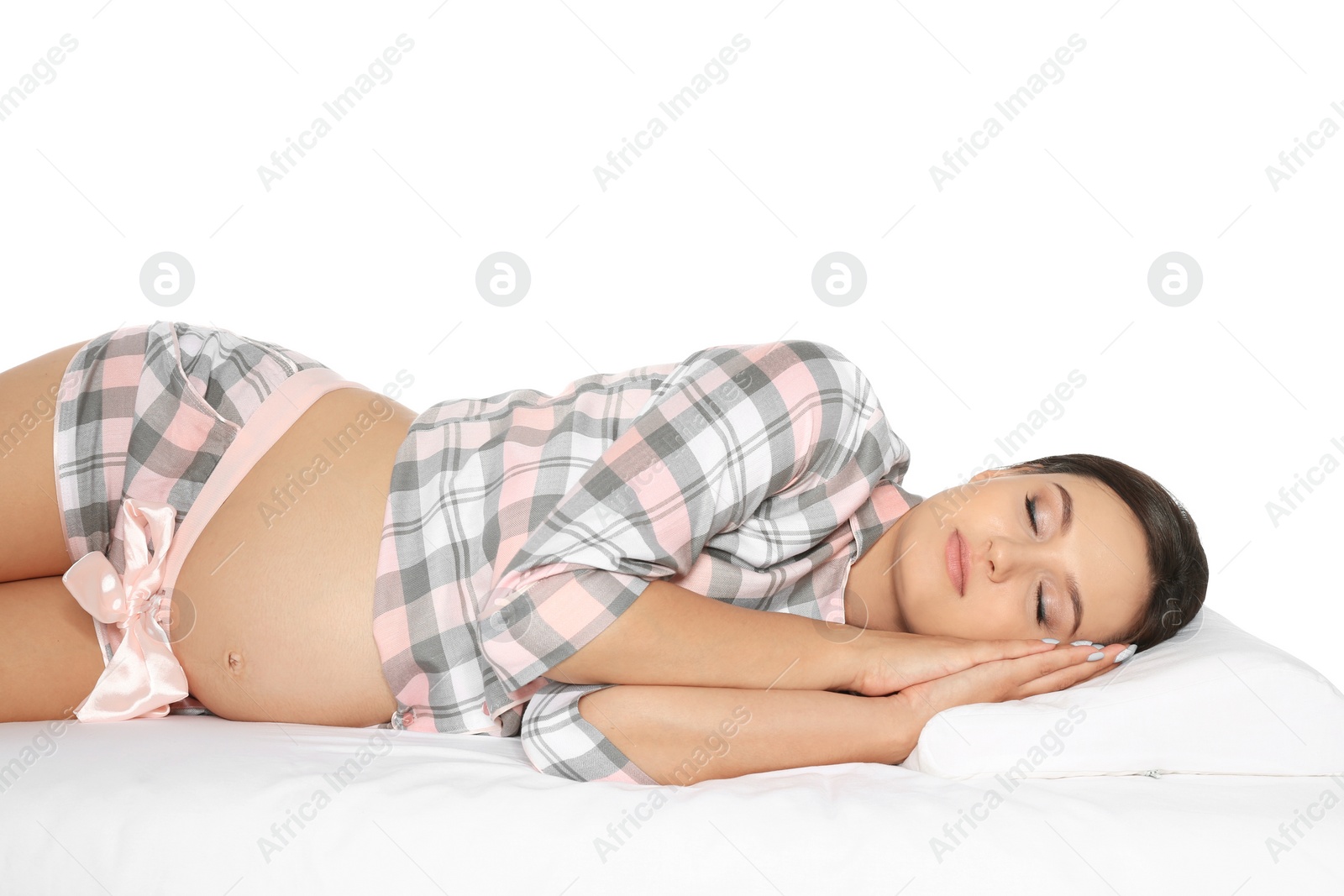 Photo of Beautiful pregnant woman sleeping with orthopedic pillow on bed against white background