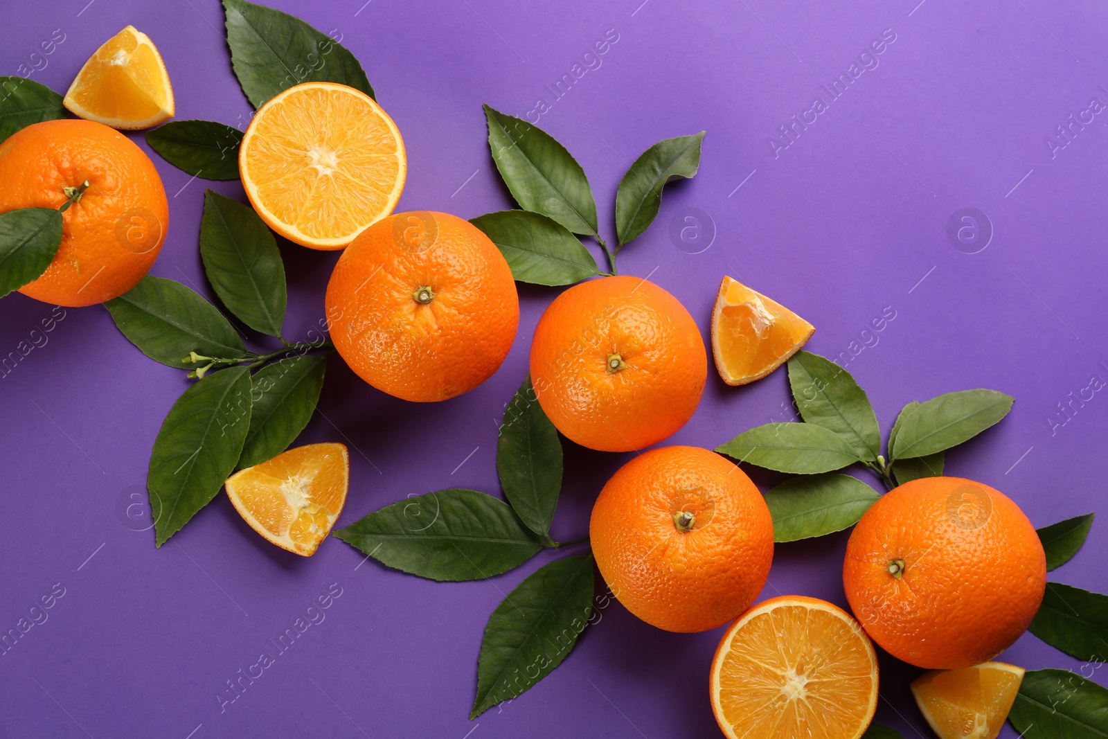 Photo of Delicious oranges on purple background, flat lay