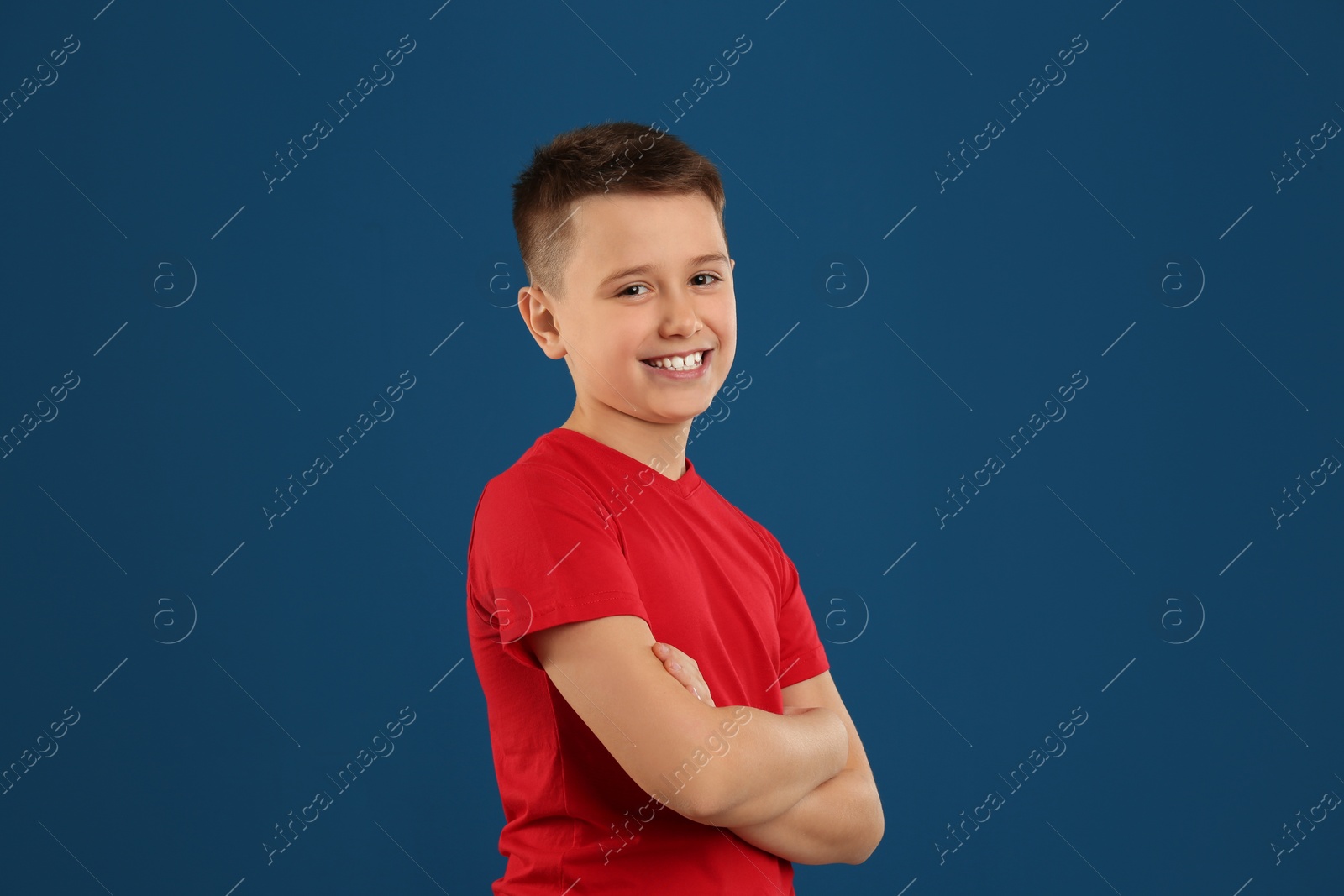 Photo of Portrait of preteen boy on blue background