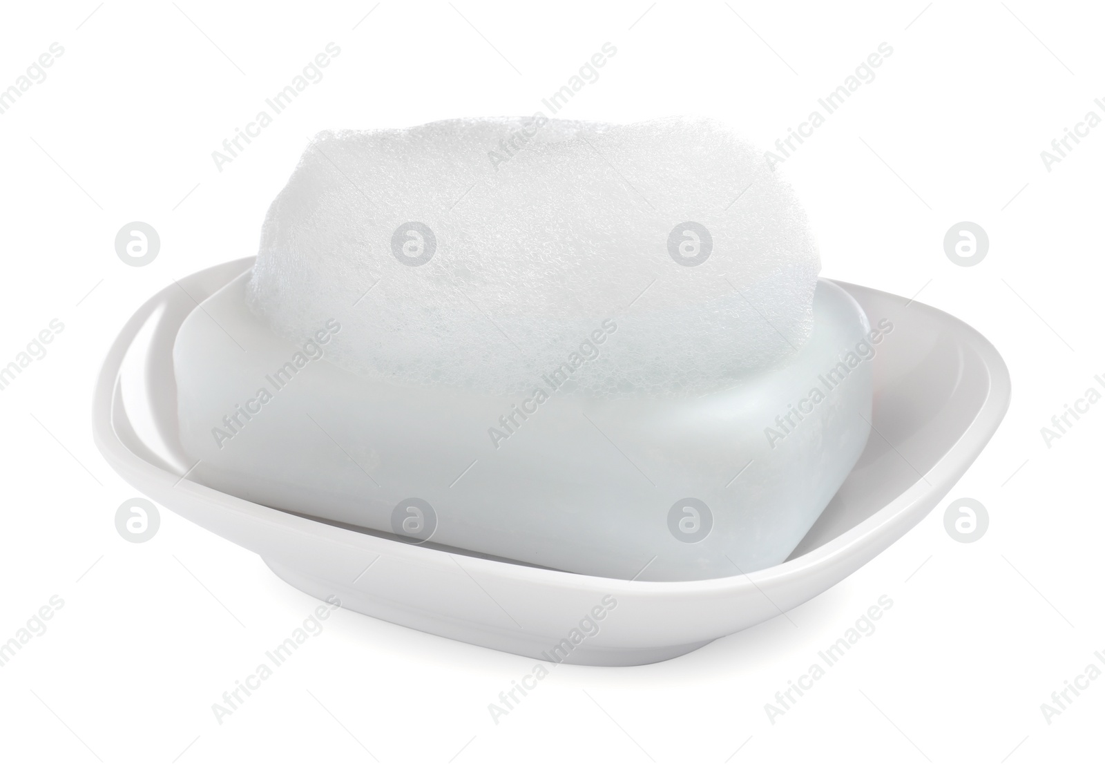 Photo of Soap bar with fluffy foam in holder on white background