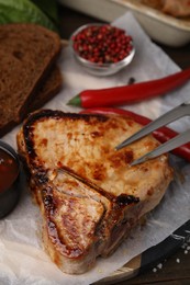 Photo of Tasty marinated meat, chili and bread on table, closeup