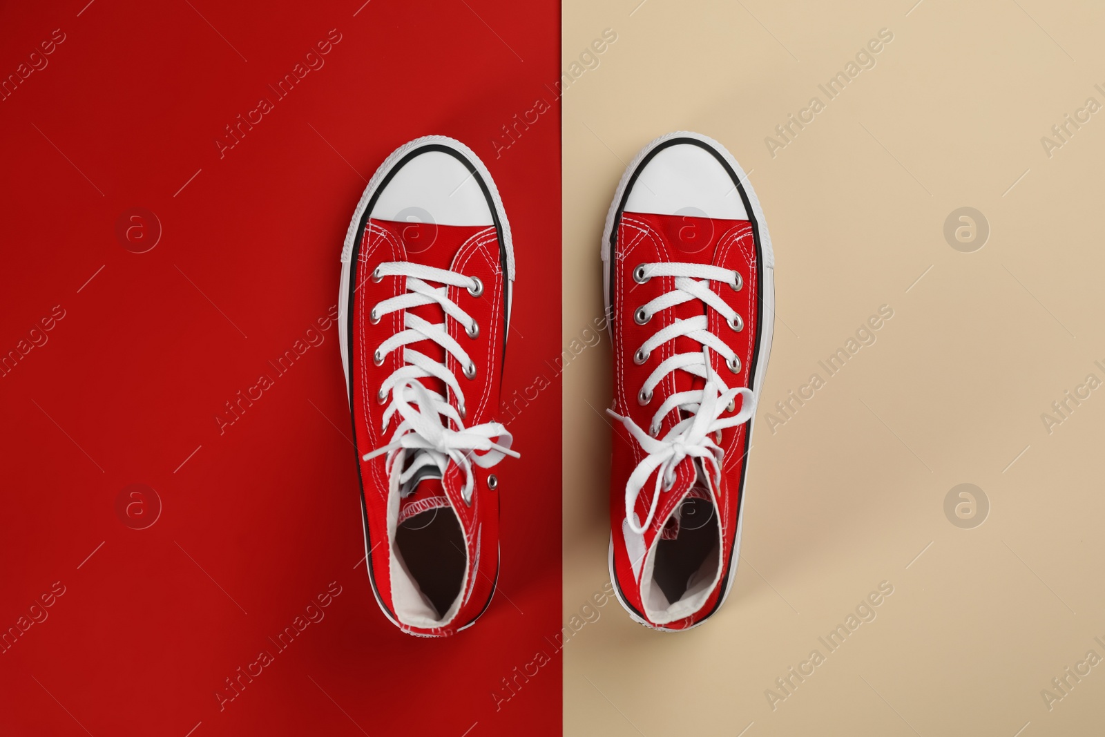 Photo of Stylish sneakers on color background, flat lay