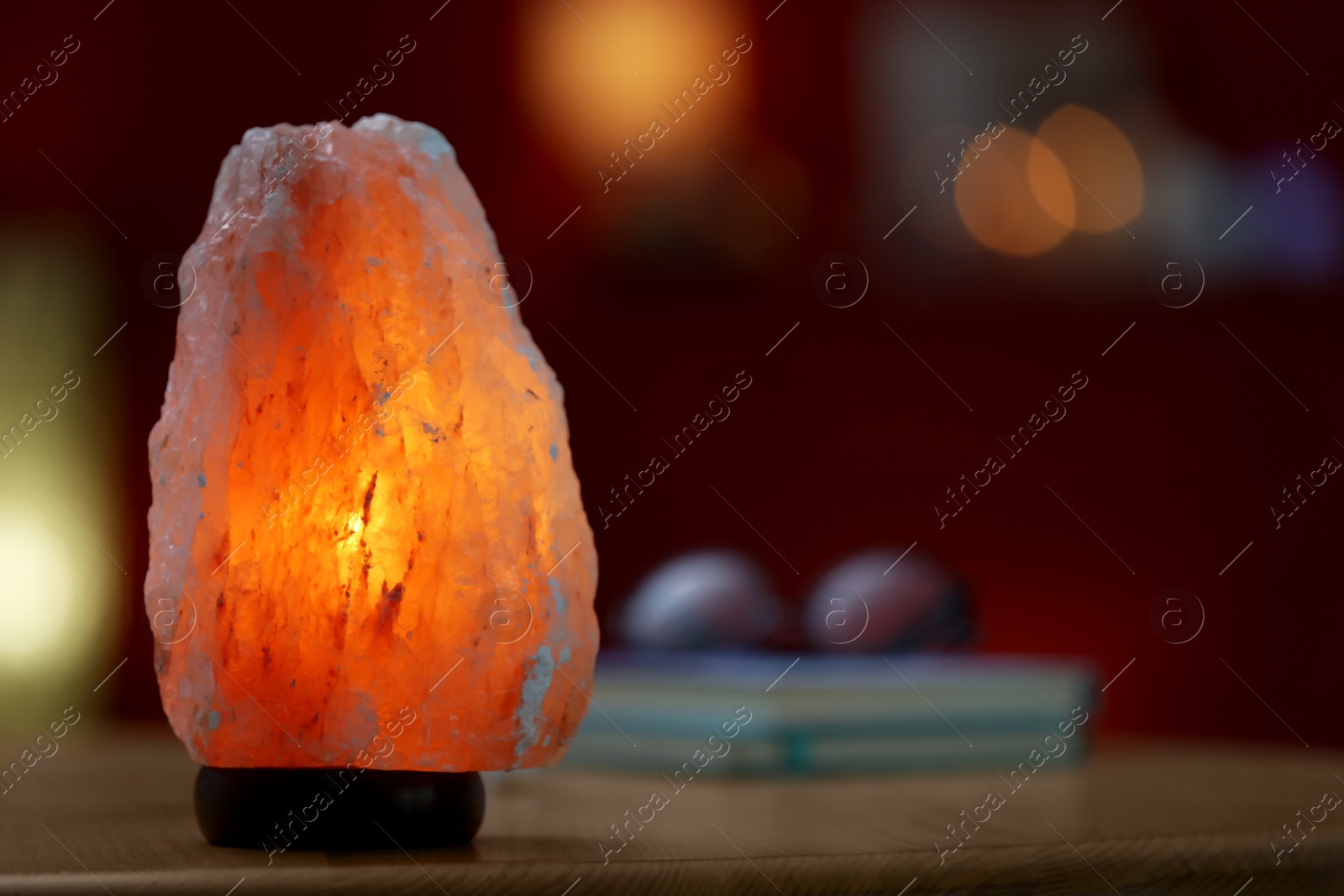 Photo of Himalayan salt lamp on table indoors, space for text