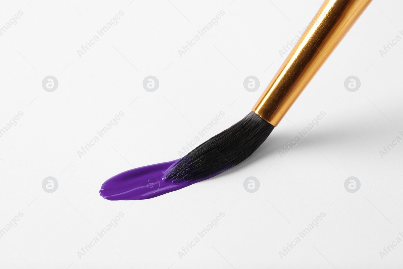 Photo of Brush with color paint and stroke on white background