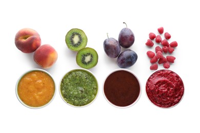 Different puree in bowls and fresh ingredients on white background, top view