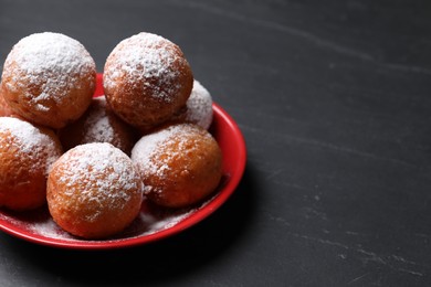 Photo of Delicious sweet buns on dark gray table, space for text