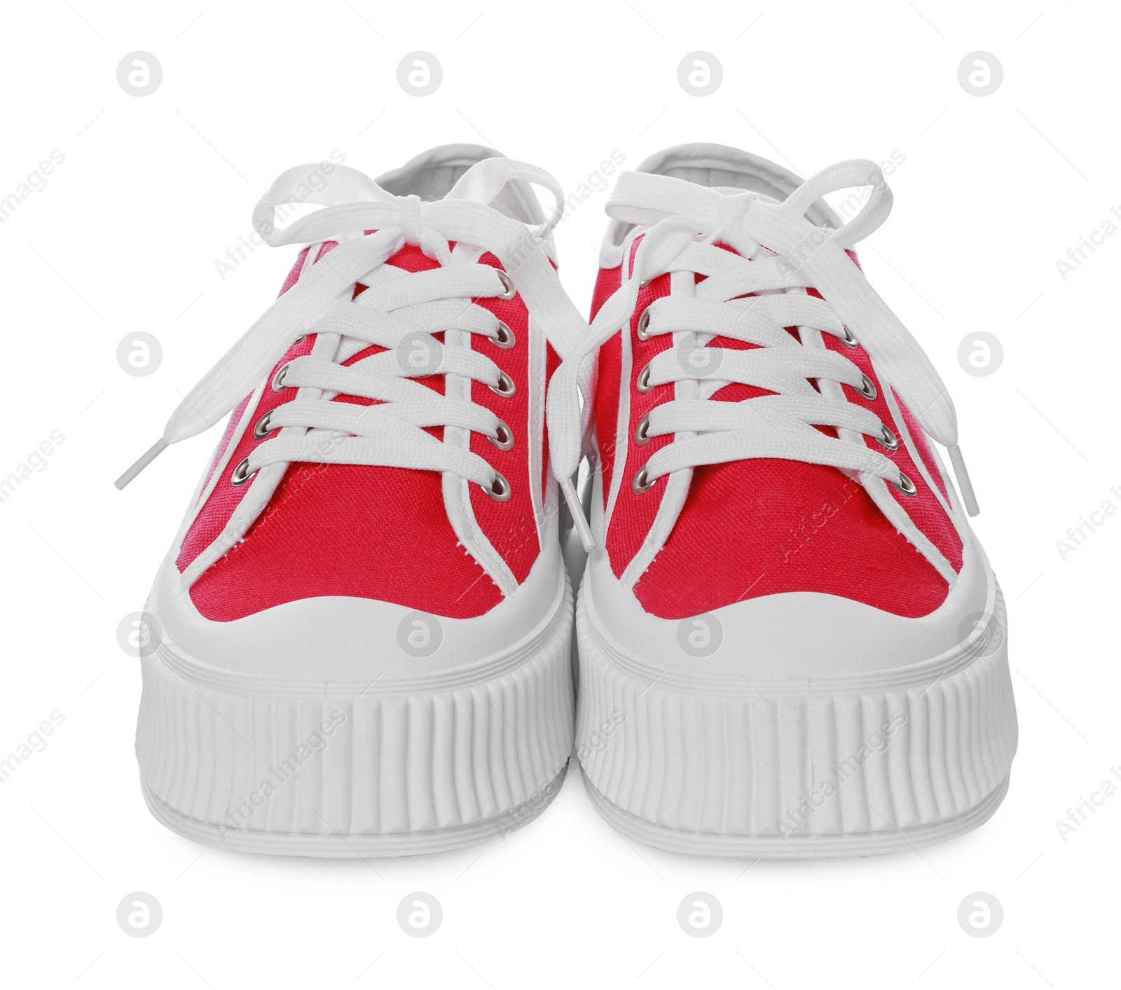 Photo of Pair of red classic old school sneakers on white background