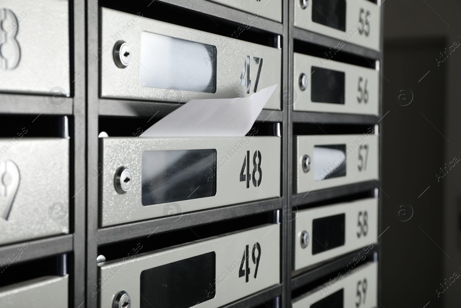 Photo of New mailboxes with keyholes, numbers and receipts, closeup