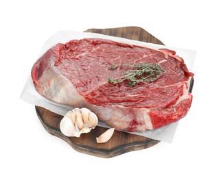Photo of Wooden board with piece of raw meat, garlic and thyme isolated on white