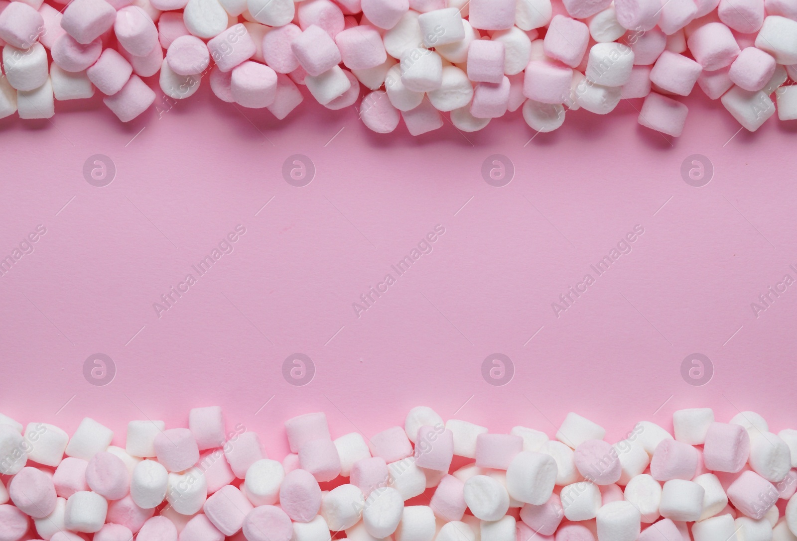 Photo of Delicious marshmallows on pink background, flat lay. Space for text