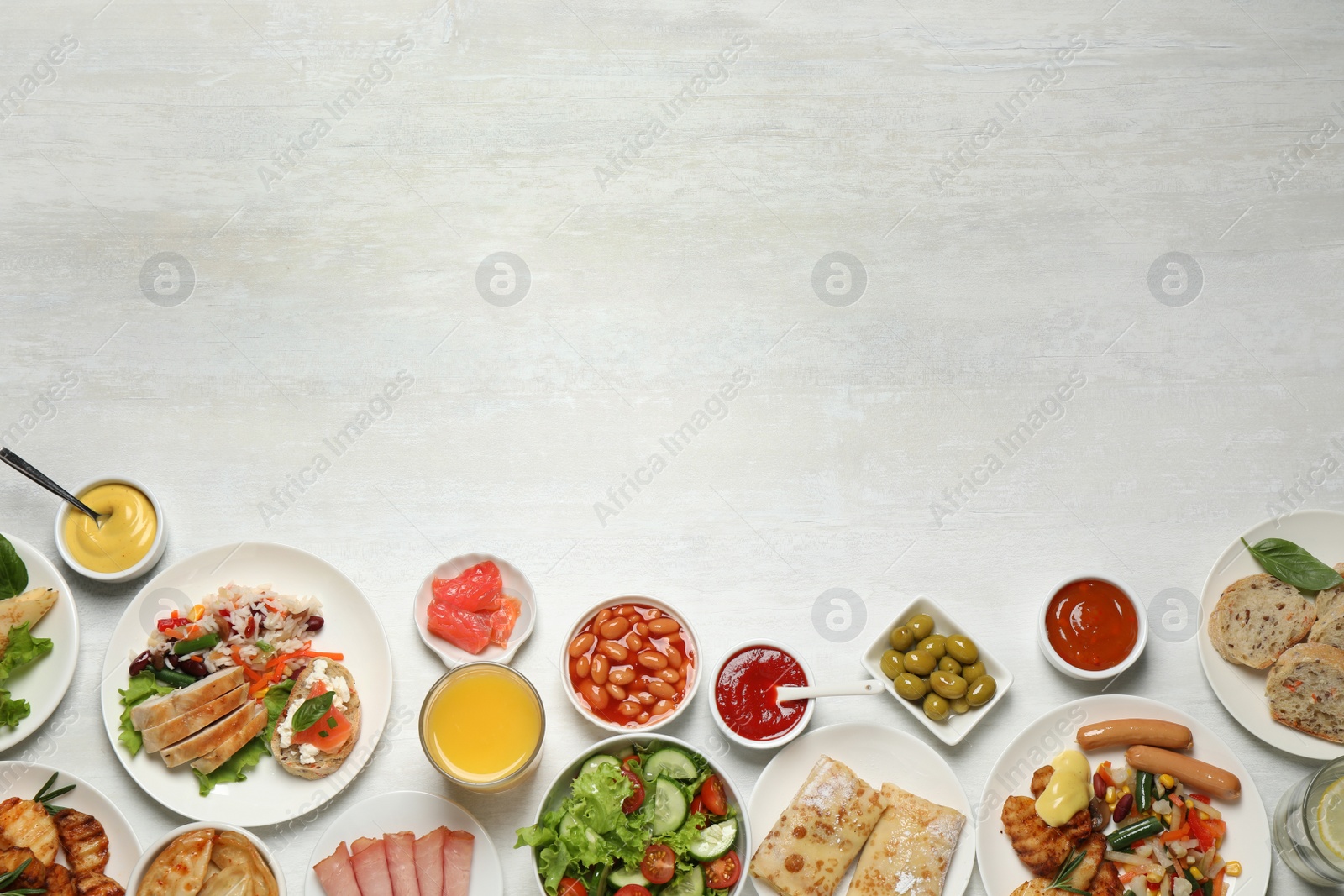 Photo of Buffet service. Flat lay composition with different dishes on white wooden table, space for text