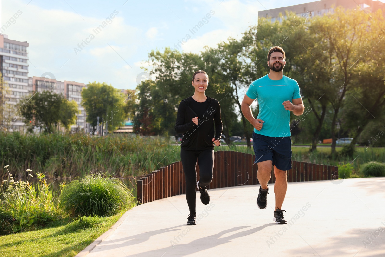 Photo of Healthy lifestyle. Happy couple running outdoors, space for text