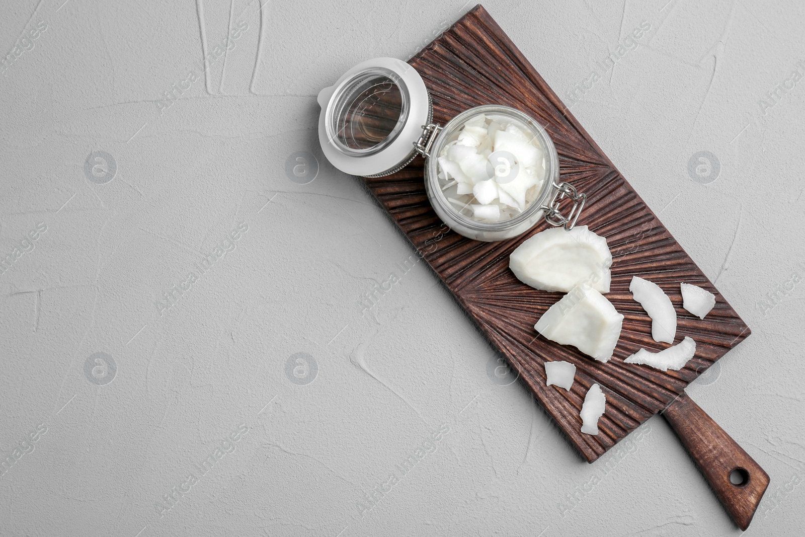 Photo of Composition with fresh coconut flakes on light background, top view