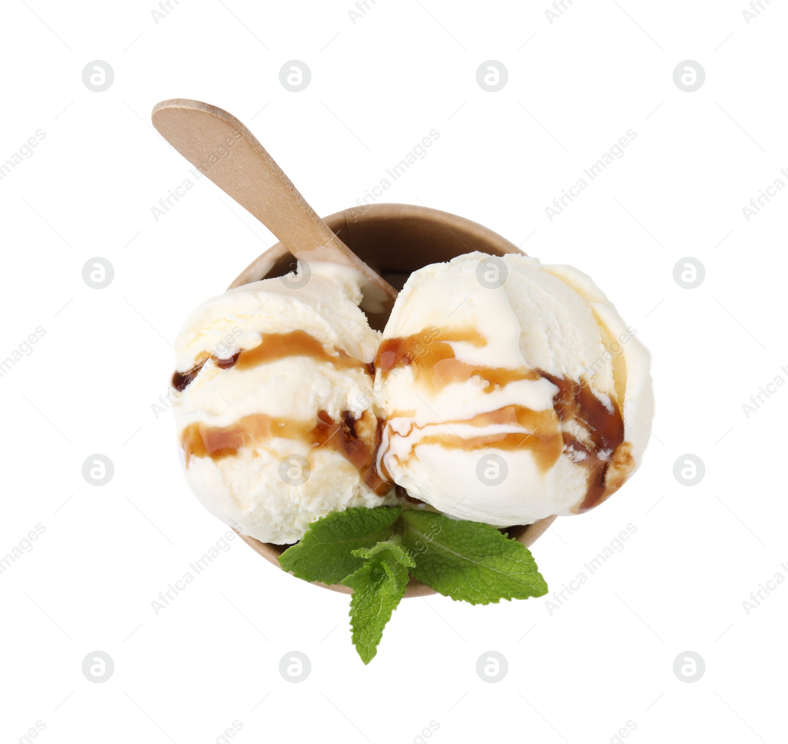 Photo of Scoops of delicious ice cream with caramel sauce and mint in paper cup isolated on white, top view