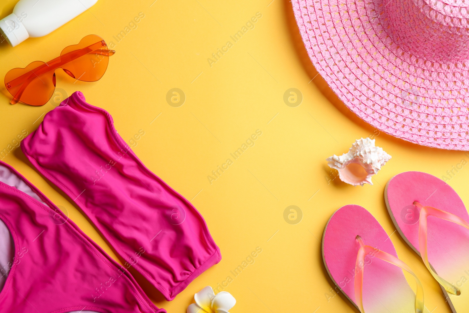 Photo of Flat lay composition with beach accessories on color background. Space for text