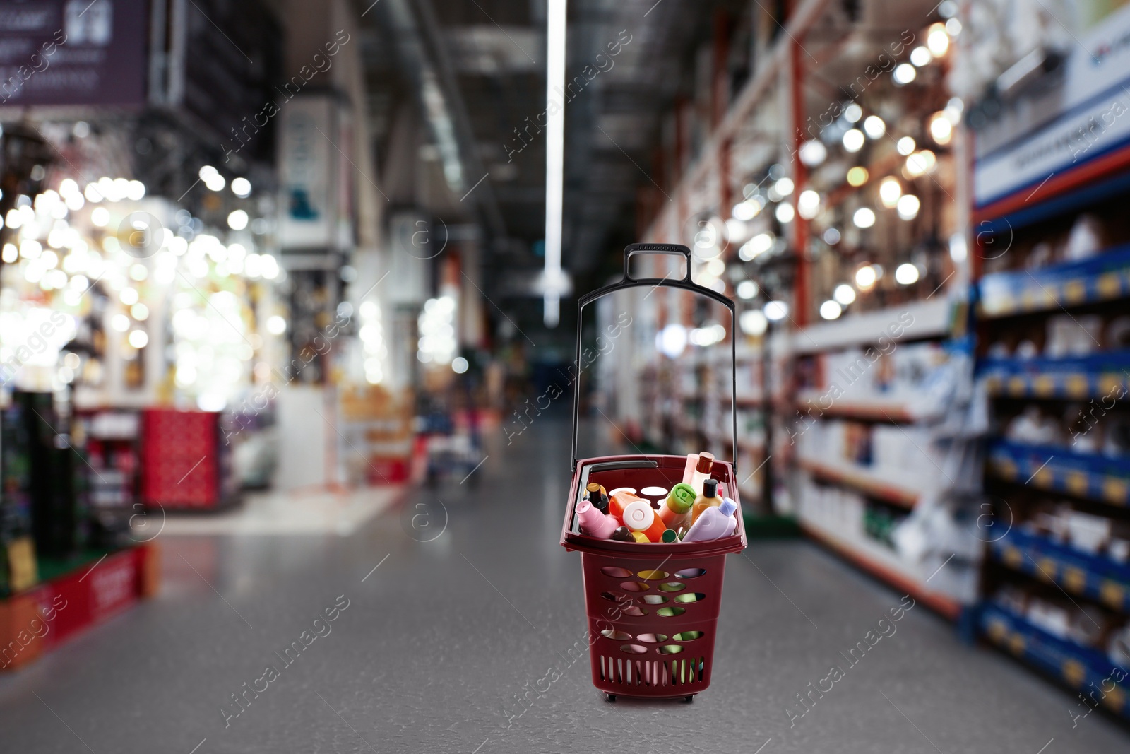 Image of Shopping basket full of cleaning supplies in mall