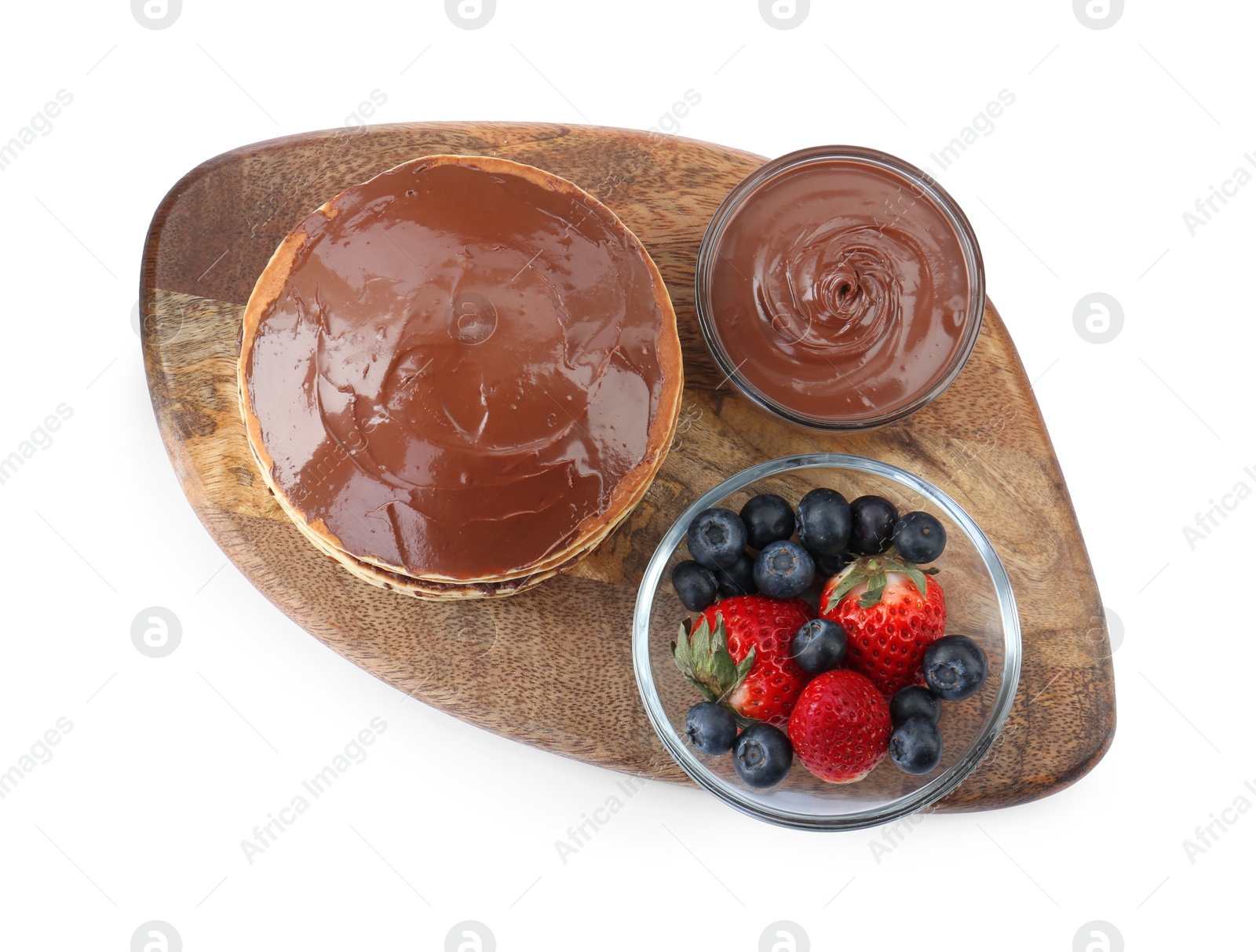 Photo of Tasty pancakes with chocolate paste and berries isolated on white, top view