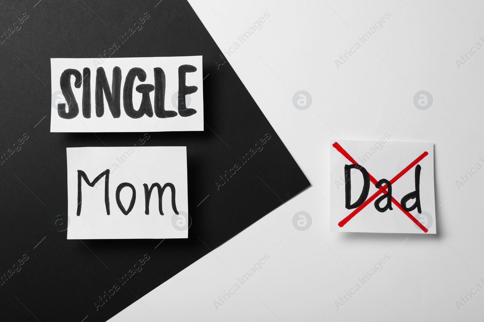 Photo of Cards with text Single Mom and crossed word Dad on color background, flat lay