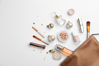 Flat lay composition with decorative cosmetic products and bag on light background. Winter care