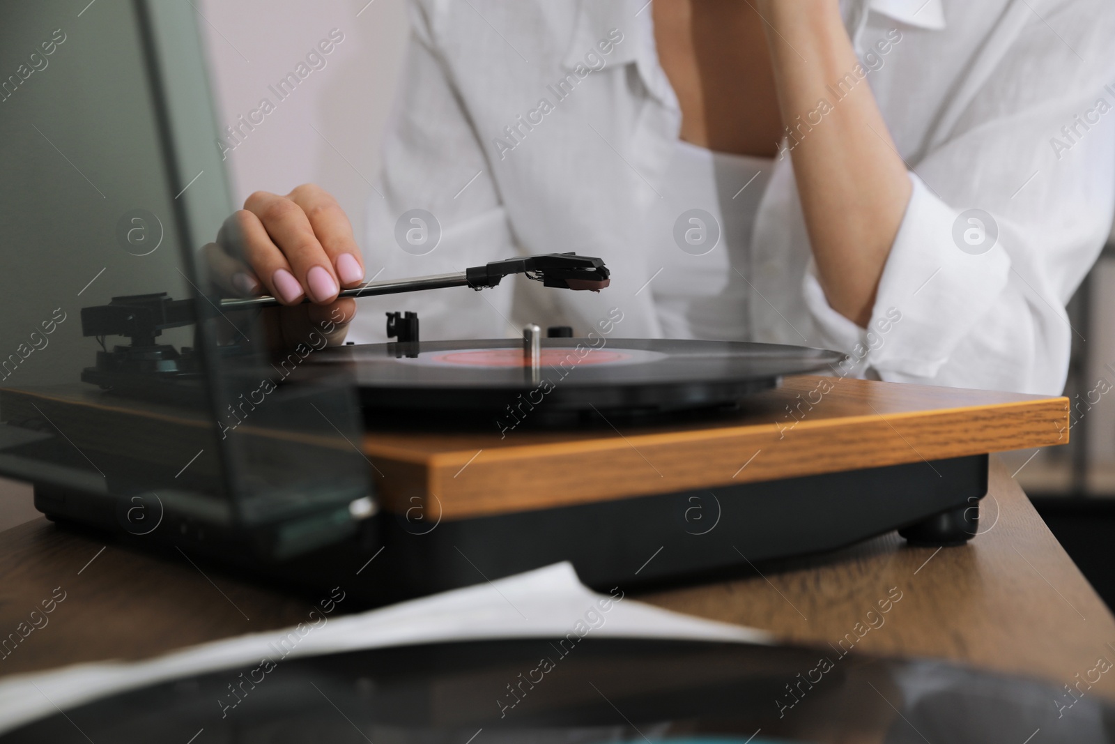 Photo of Woman using turntable at home, closeup view