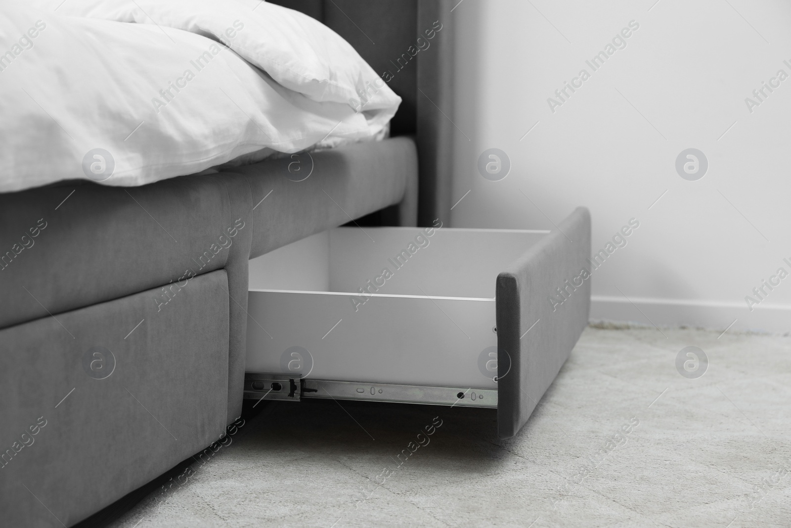 Photo of Storage drawer for bedding under modern bed in room