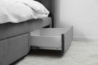 Storage drawer for bedding under modern bed in room