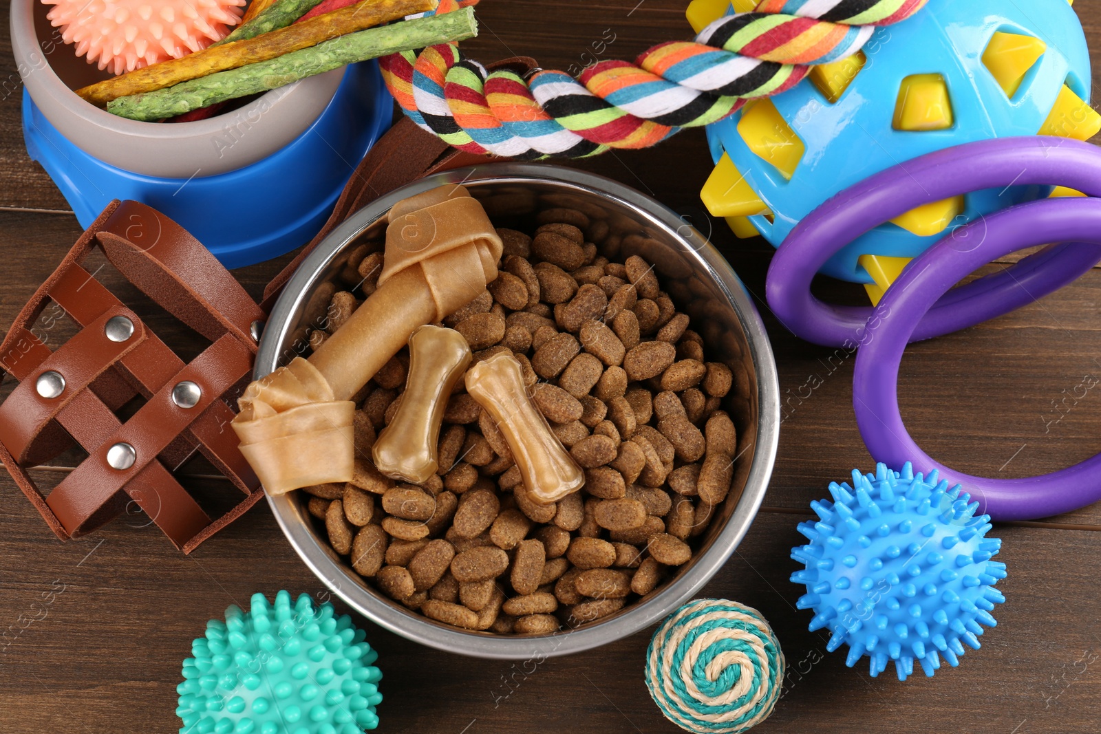 Photo of Different pet goods on wooden table, above view. Shop assortment