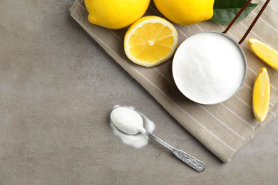 Photo of Baking soda and cut lemons on light table, flat lay