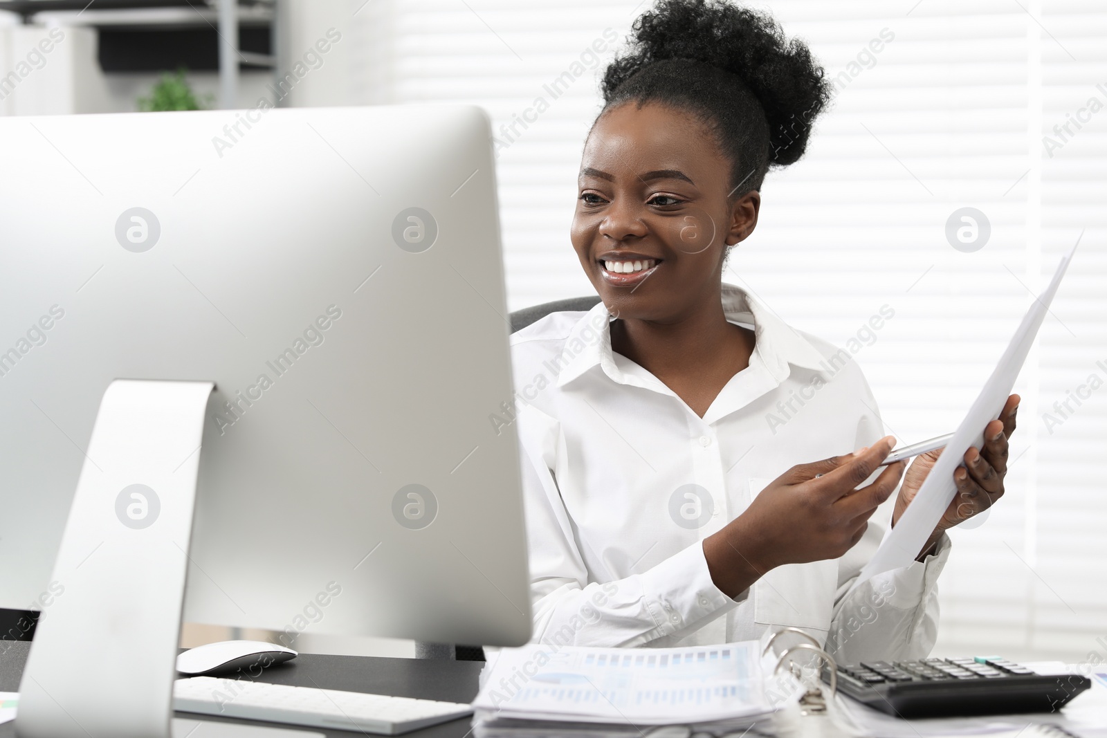 Photo of Professional accountant having video chat via computer at desk in office