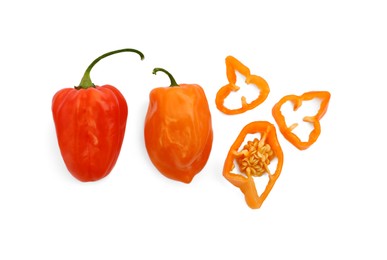 Photo of Whole and cut hot chili peppers on white background, flat lay