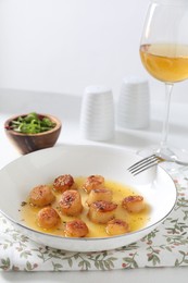 Photo of Delicious fried scallops served on white table