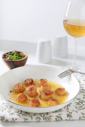 Delicious fried scallops served on white table