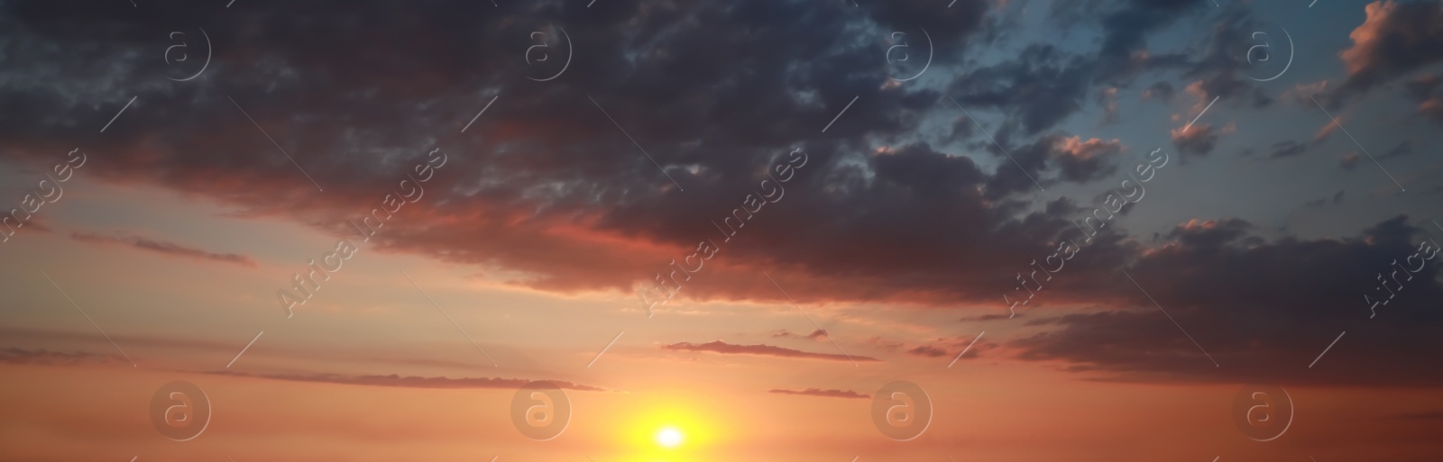 Image of Sun shining on beautiful cloudy sky at sunset, banner design