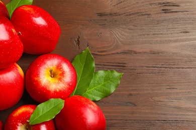 Ripe red apples on wooden background