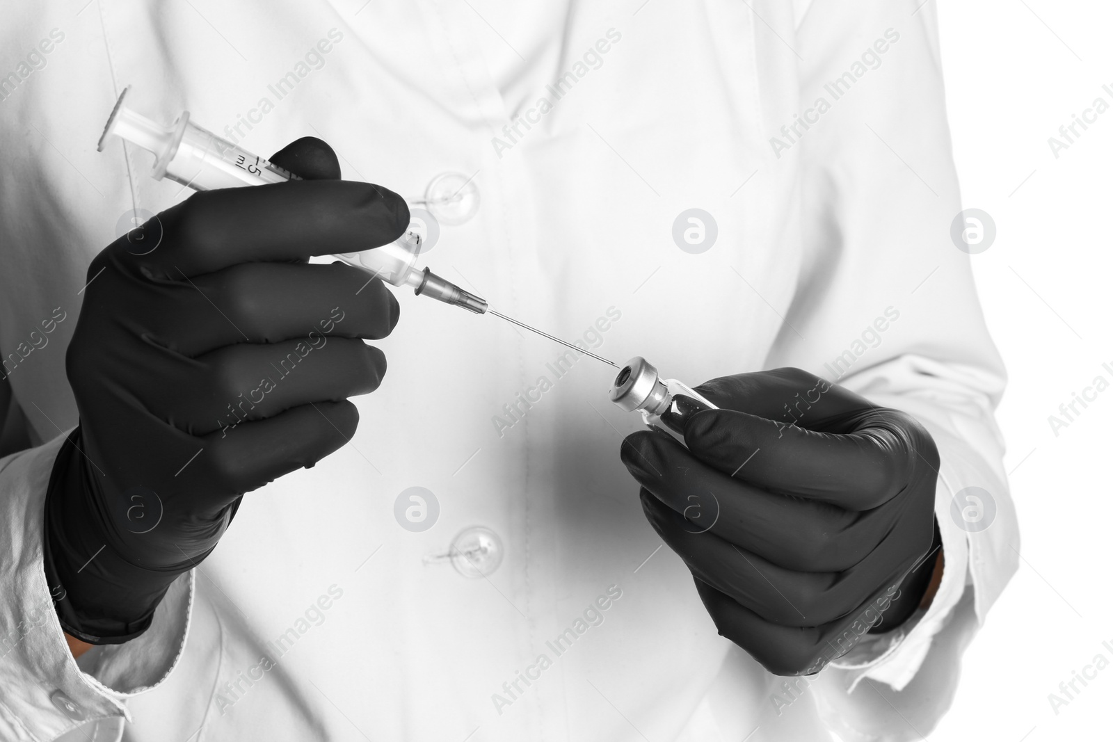 Photo of Doctor in medical gloves with syringe and vial, closeup