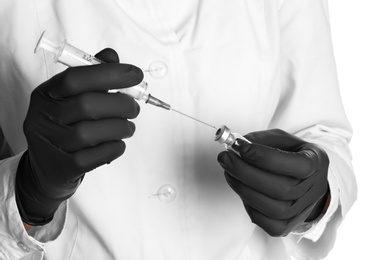 Photo of Doctor in medical gloves with syringe and vial, closeup