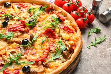 Delicious pizza with olives and sausages on table, closeup