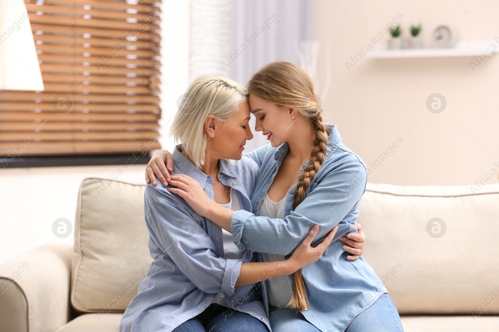 Photo of Mother and her adult daughter spending time together at home