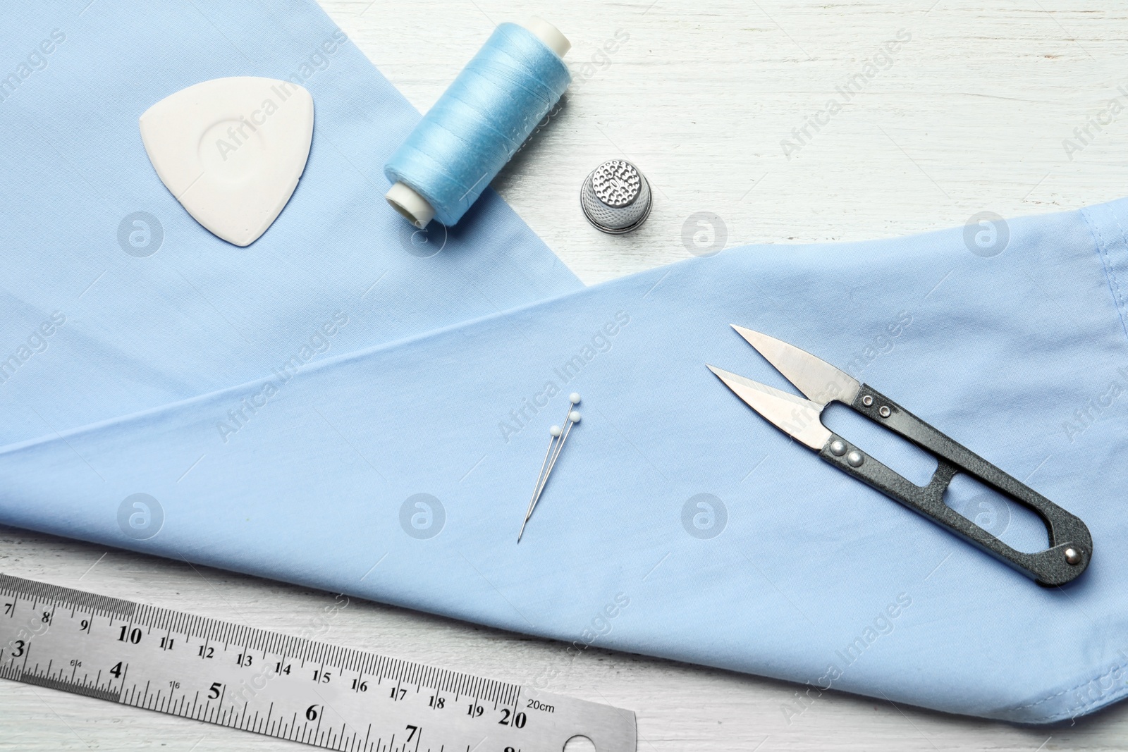 Photo of Flat lay composition with accessories for tailoring on wooden table