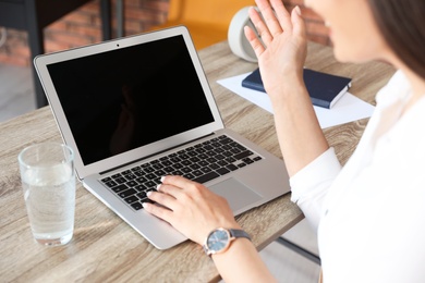 Photo of Woman using video chat on laptop in home office, closeup. Space for text