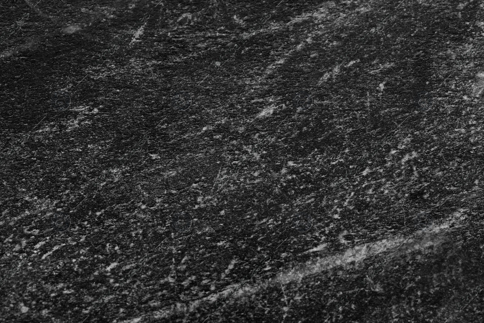 Photo of Texture of black marble surface as background, closeup