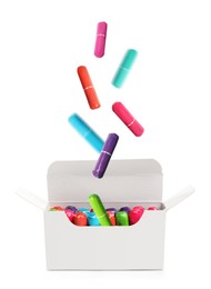 Image of Many tampons falling into box on white background 