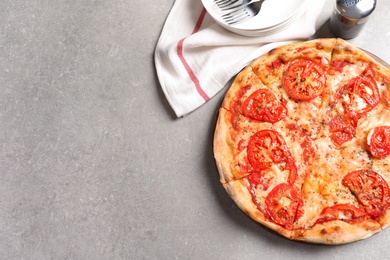 Photo of Hot cheese pizza Margherita on grey table, top view. Space for text